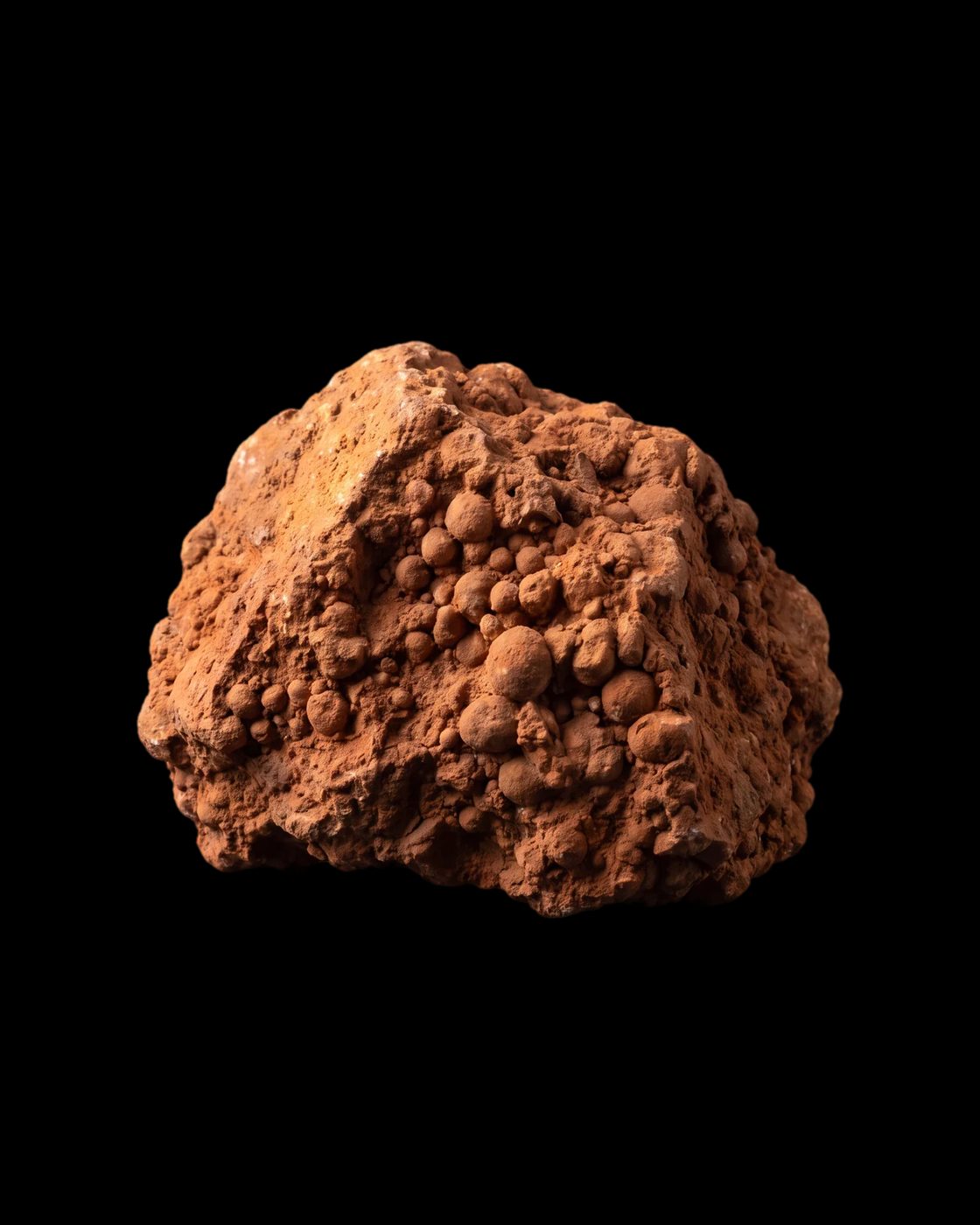 A lump of reddish-brown bauxite made of small rounded grains