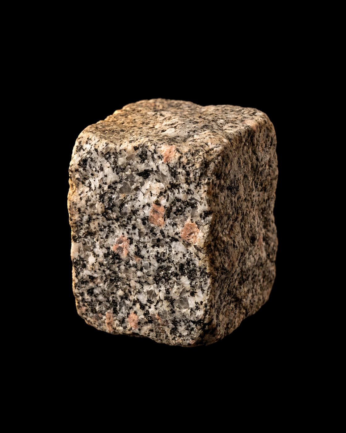 A rough block of speckled granite, black, white and grey with a little pink