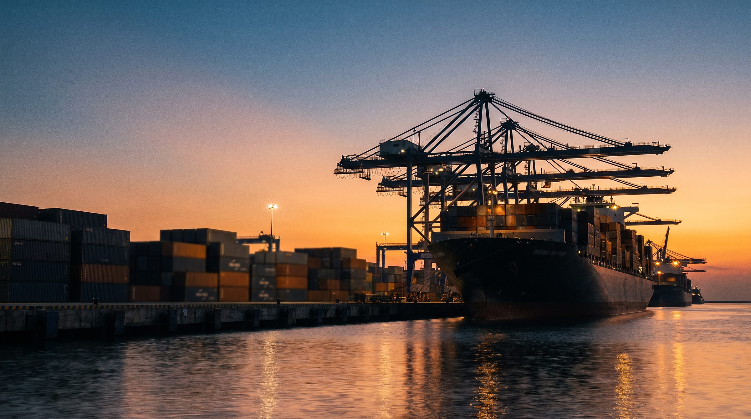 A container ship at an Indian port at dusk